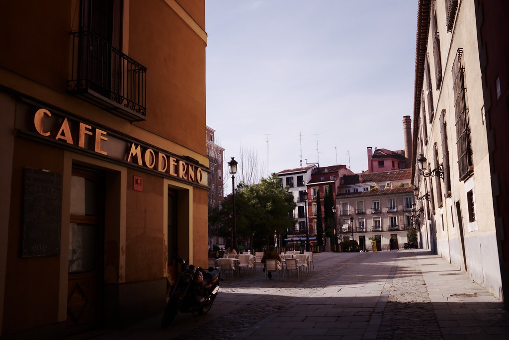 A cafe on a Spanish street with outdoor tables — the everyday setting where GCSE Spanish speaking practice really happens: reading the menu aloud, ordering, and asking for the bill